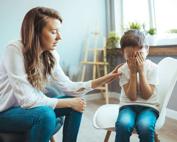 Image of Mother comforting child crying